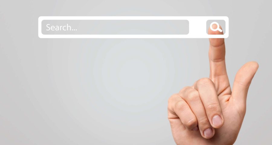 grey screen with white search bar and finer pointing to it