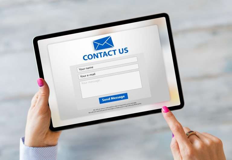 person clicking contact form on tablet