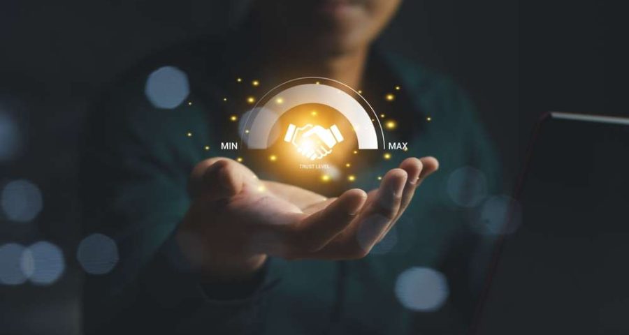 holographic image of human holding a graphic of a yellow glowing handshake