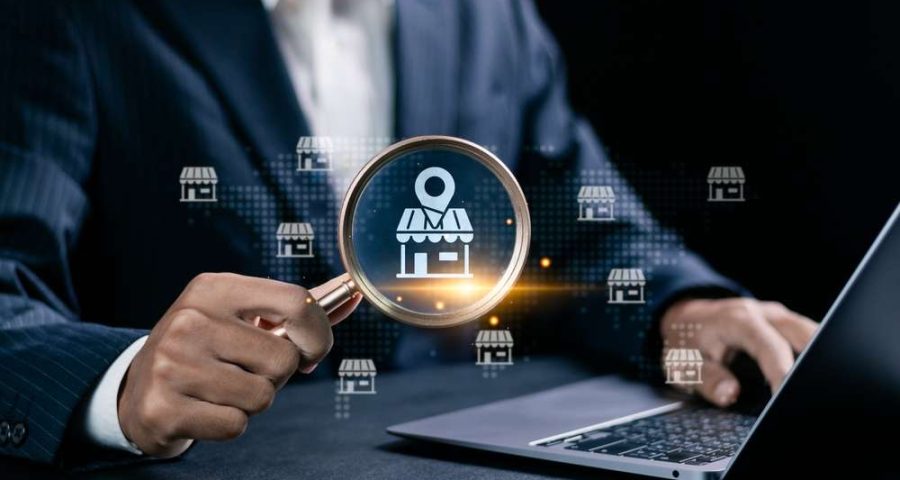 Businessman use laptop with local marketplace icons on virtual screen