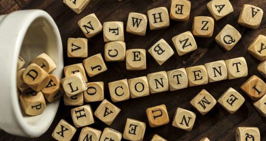 A photograph of wooden blocks spelling out "content".