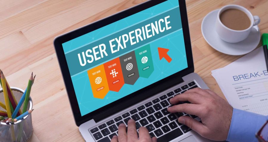 man holding computer with user experience logo