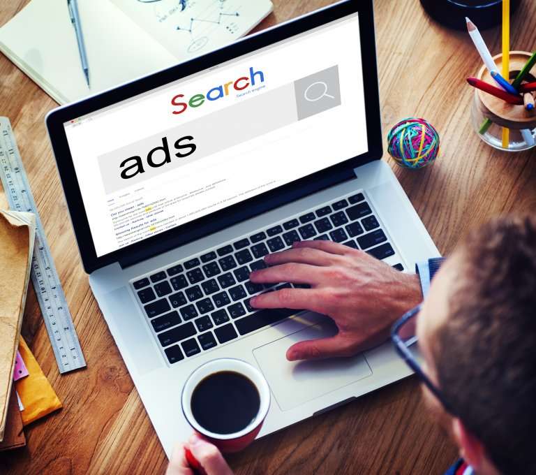 search ads on a mans laptop