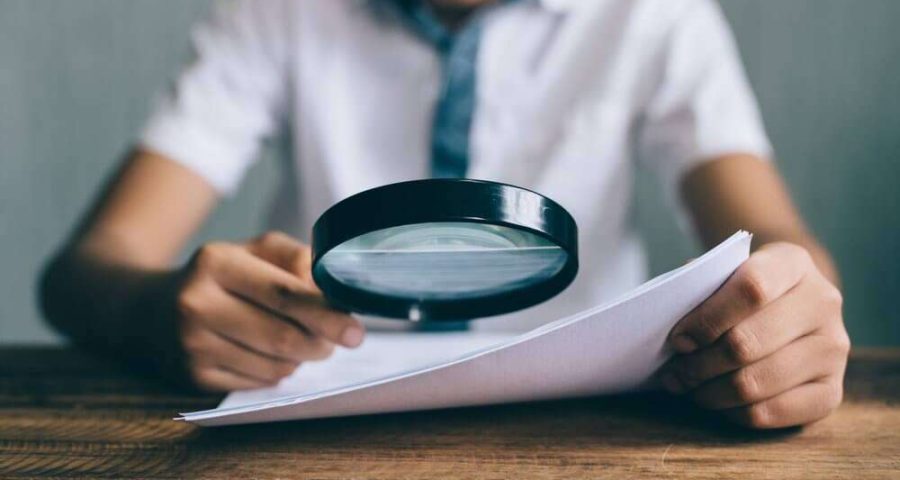 boy holding up magnifying glass